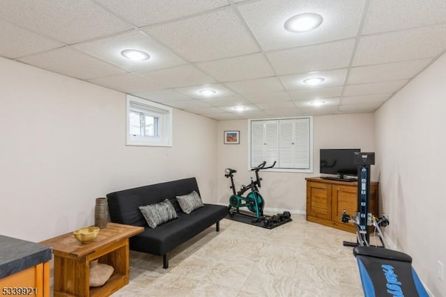 exercise room featuring a paneled ceiling, baseboards, and recessed lighting