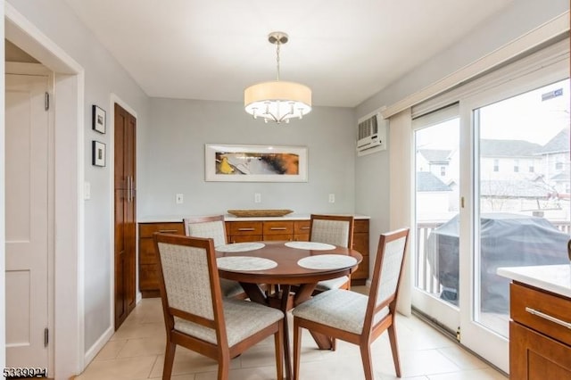 dining room with light tile patterned floors, a wall mounted air conditioner, and an inviting chandelier