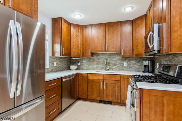 kitchen featuring stainless steel appliances, brown cabinets, and light countertops