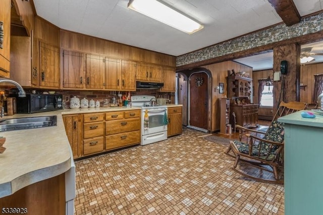 kitchen featuring brown cabinets, light countertops, white electric range, under cabinet range hood, and a sink