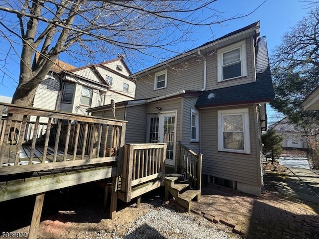 back of house featuring a wooden deck