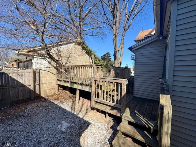 wooden terrace featuring fence