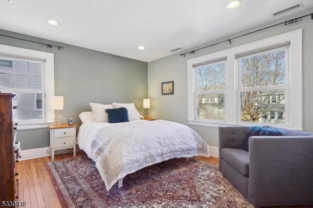 bedroom with light wood-type flooring, baseboards, visible vents, and recessed lighting