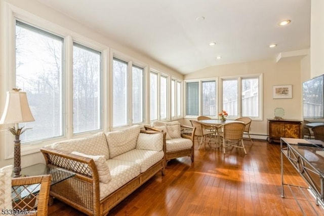 sunroom / solarium with lofted ceiling and a baseboard radiator