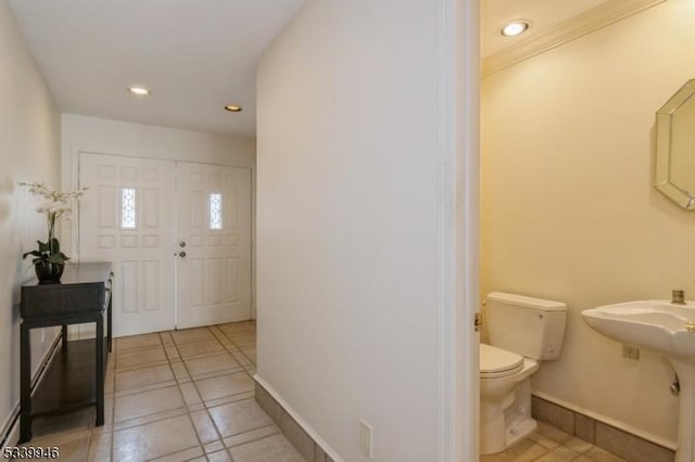 entrance foyer with recessed lighting, baseboards, and light tile patterned floors