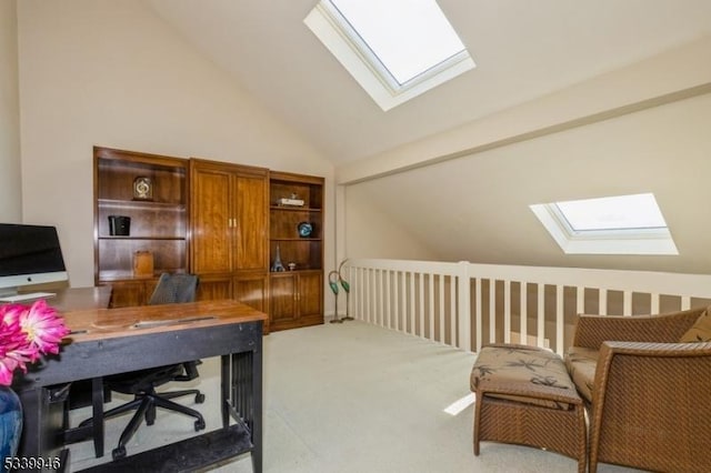 home office with light carpet and vaulted ceiling with skylight