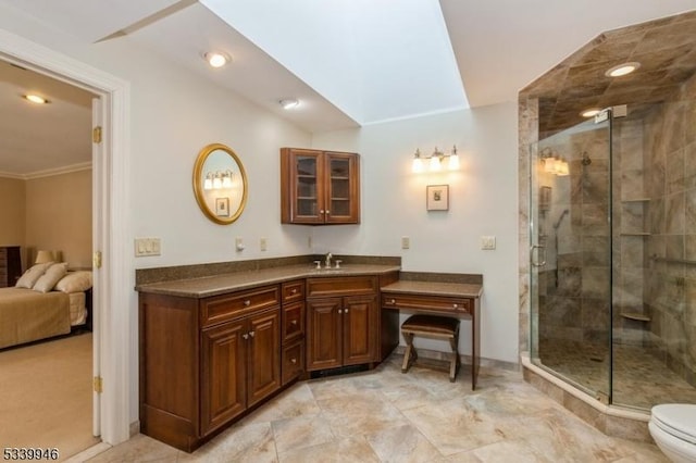 bathroom featuring a stall shower, toilet, ensuite bathroom, crown molding, and vanity