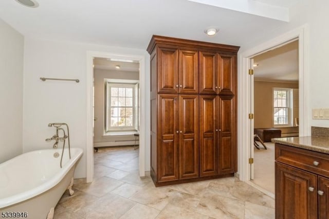 full bathroom featuring a soaking tub and vanity