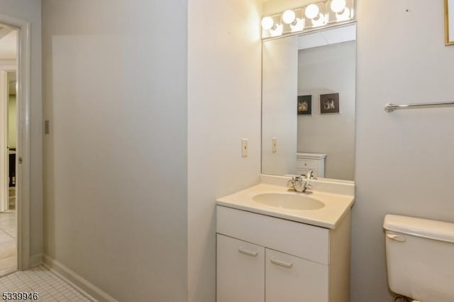 bathroom with vanity, toilet, and tile patterned floors