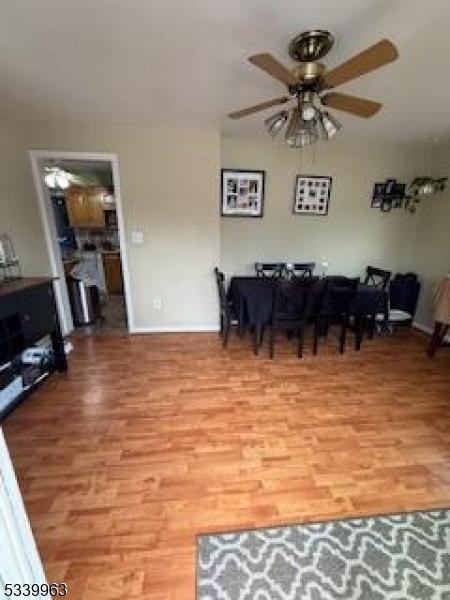 interior space featuring a ceiling fan and light wood-style floors