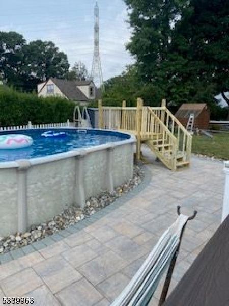 pool featuring a patio area and fence