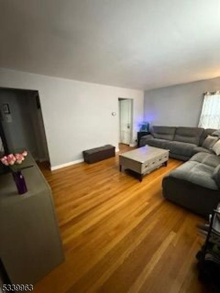 living area featuring baseboards and wood finished floors