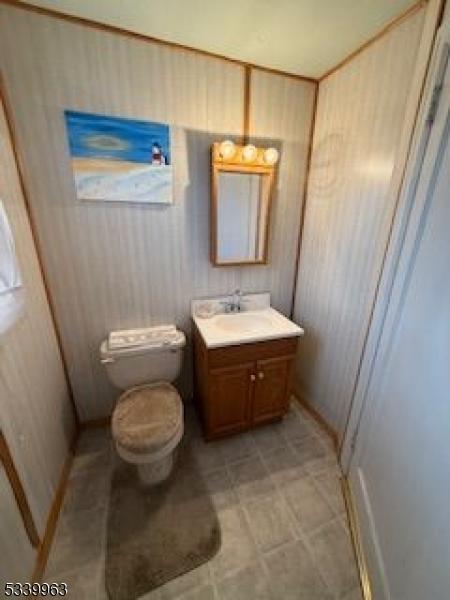 half bathroom with toilet and vanity