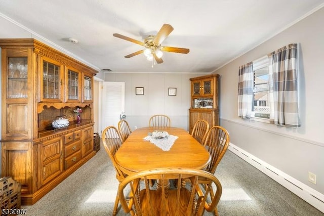 dining area with ceiling fan, carpet flooring, baseboards, ornamental molding, and baseboard heating