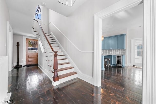 staircase with hardwood / wood-style flooring and baseboards