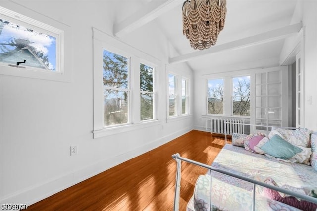 bedroom with radiator, vaulted ceiling with beams, wood-type flooring, and baseboards