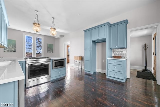 kitchen featuring baseboards, dark wood-style floors, stainless steel electric stove, light countertops, and backsplash