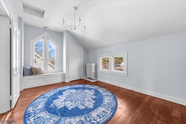 bonus room with attic access, visible vents, radiator heating unit, wood finished floors, and vaulted ceiling