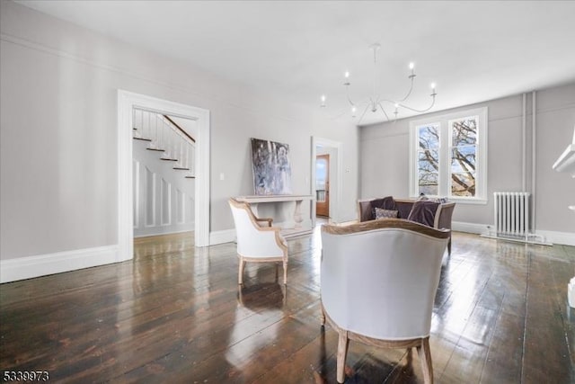 interior space featuring baseboards, radiator, hardwood / wood-style flooring, stairs, and a notable chandelier