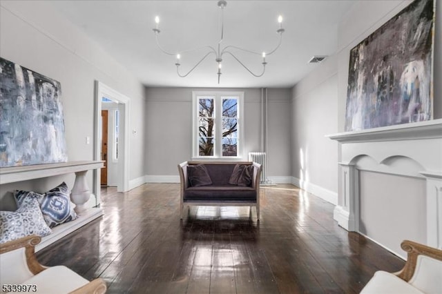 sitting room featuring baseboards, visible vents, and hardwood / wood-style floors