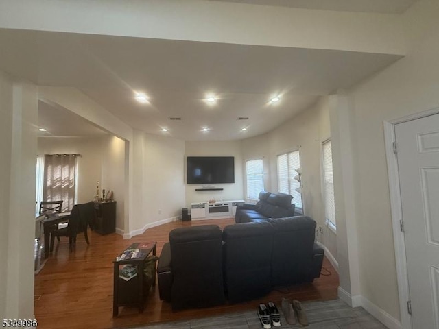 living room featuring recessed lighting, wood finished floors, visible vents, and baseboards