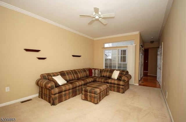 carpeted living room featuring a ceiling fan, baseboards, visible vents, and crown molding