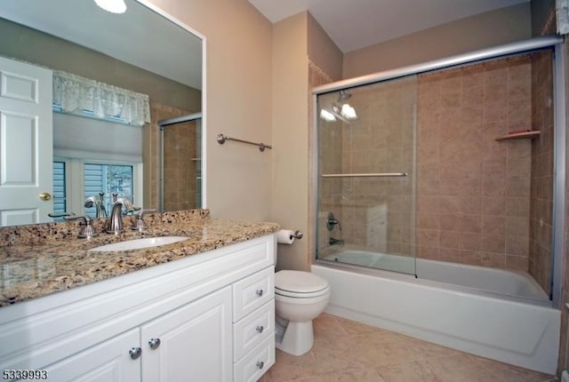 full bathroom featuring toilet, tile patterned floors, bath / shower combo with glass door, and vanity