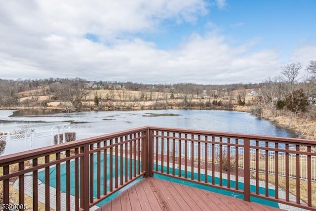 wooden deck featuring fence and a water view