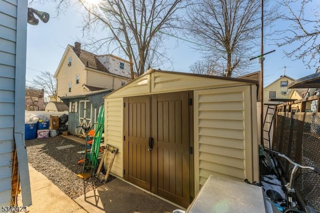 view of shed with fence