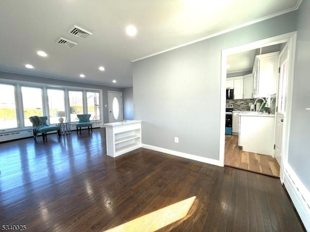 unfurnished living room with dark wood finished floors, recessed lighting, visible vents, ornamental molding, and baseboards