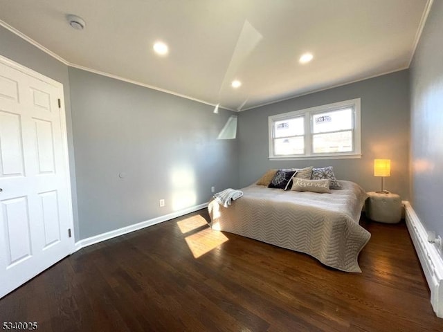 bedroom featuring baseboards, crown molding, and wood finished floors