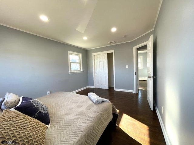 bedroom featuring recessed lighting, visible vents, baseboards, dark wood finished floors, and crown molding