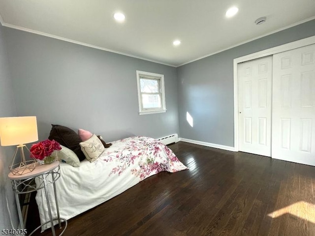 bedroom with a baseboard heating unit, recessed lighting, wood finished floors, and crown molding