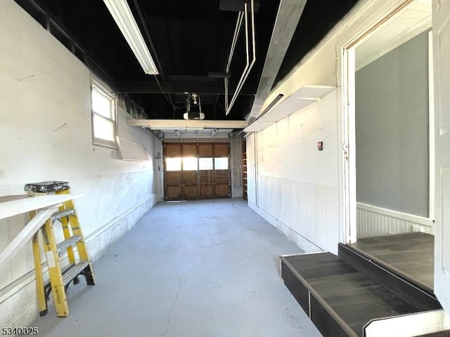 garage featuring wainscoting and a garage door opener