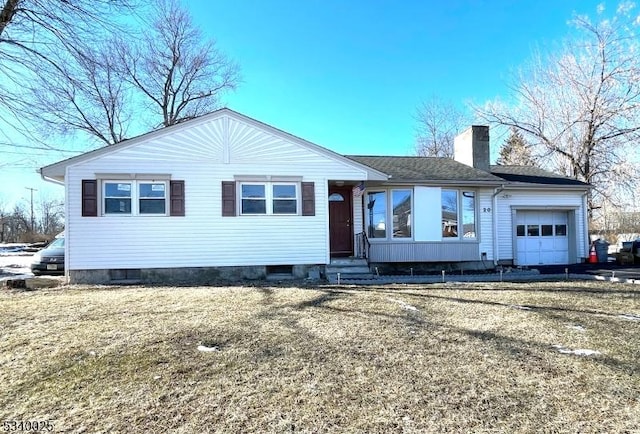 single story home with entry steps, an attached garage, roof with shingles, a front lawn, and a chimney