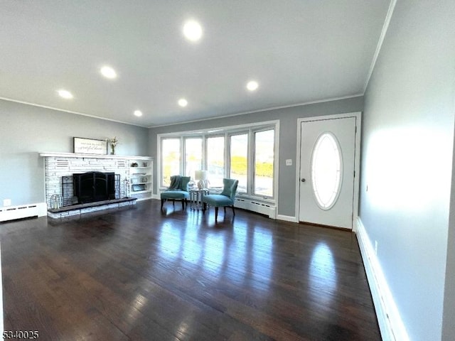 unfurnished living room with baseboards, ornamental molding, wood finished floors, a fireplace, and recessed lighting