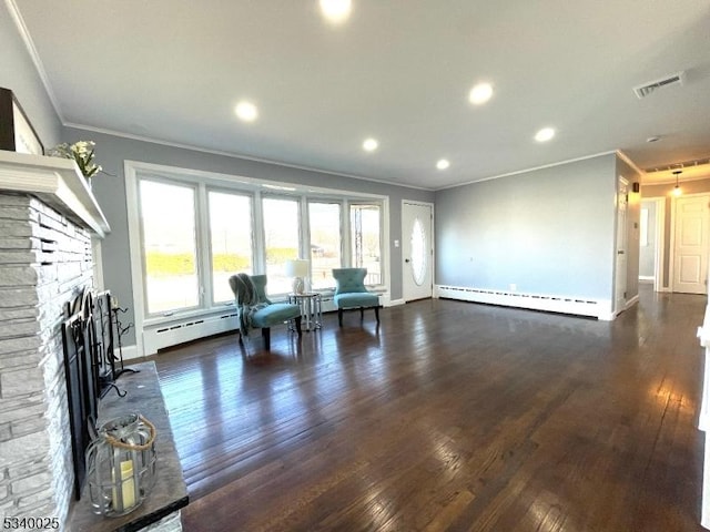 living area featuring a baseboard heating unit, visible vents, a stone fireplace, and dark wood-style floors