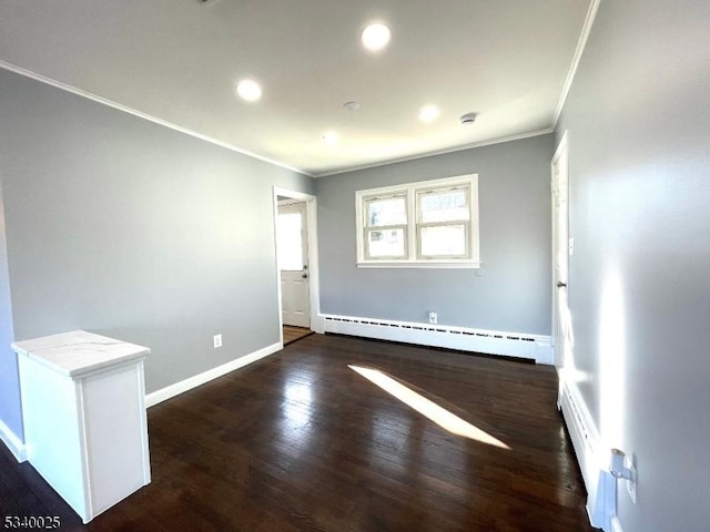 spare room with baseboards, ornamental molding, dark wood-style flooring, a baseboard heating unit, and recessed lighting