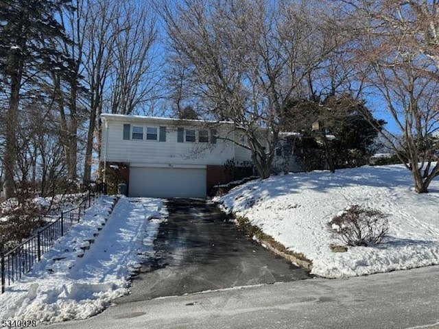 view of front of house with aphalt driveway and an attached garage