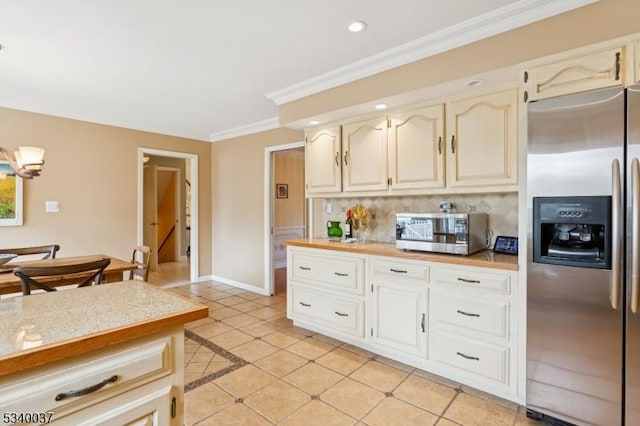 kitchen with backsplash, crown molding, baseboards, light countertops, and stainless steel appliances