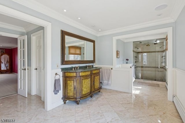 bathroom with vanity, a baseboard radiator, ornamental molding, a shower stall, and marble finish floor