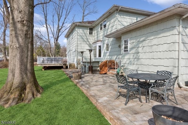 view of patio / terrace featuring outdoor dining area and a deck