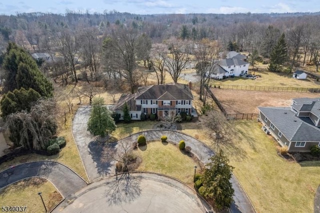 birds eye view of property featuring a wooded view