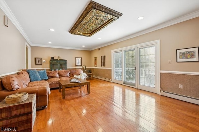 living room with crown molding, light wood finished floors, and a baseboard radiator