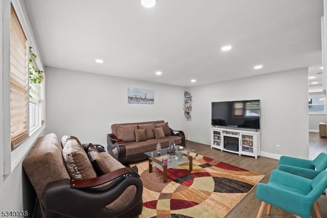 living room featuring baseboards, dark wood finished floors, and recessed lighting