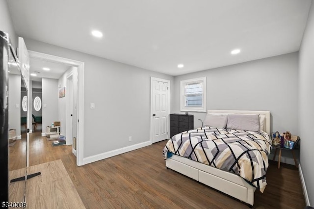 bedroom with recessed lighting, baseboards, and wood finished floors