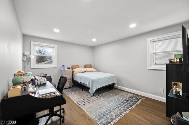 bedroom featuring dark wood-style floors, multiple windows, recessed lighting, and baseboards