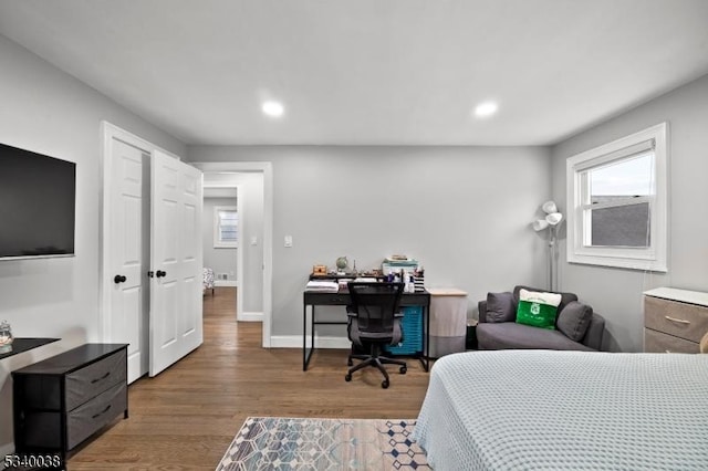 bedroom with recessed lighting, wood finished floors, and baseboards