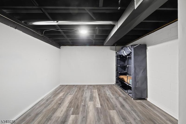 finished basement with baseboards and wood finished floors