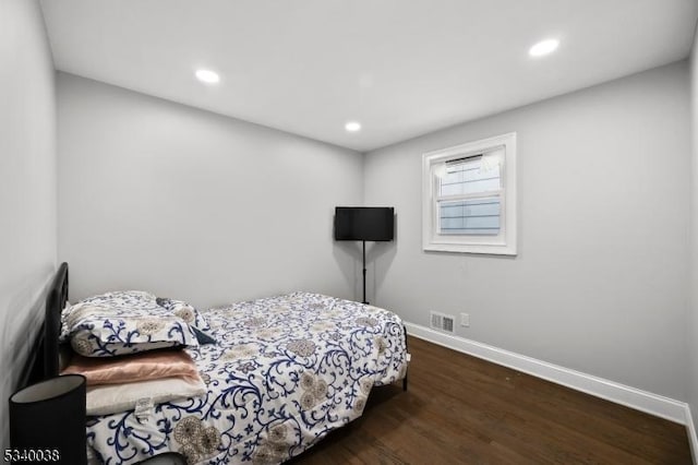 bedroom with recessed lighting, visible vents, dark wood finished floors, and baseboards